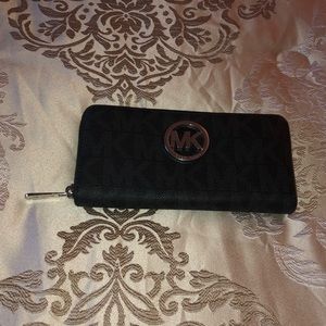 Michael Kors zipper wallet in black.